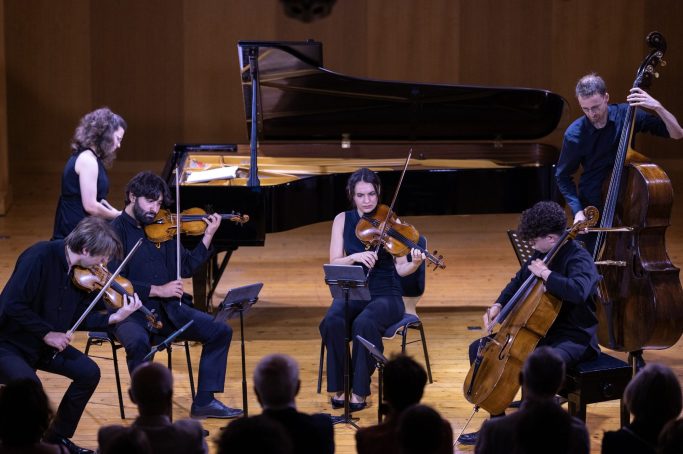 A prizewinner performing chamber music with a string ensemble